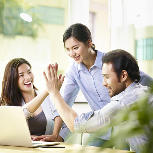 Happy Singaporean Web Designers Celebrating Client Success