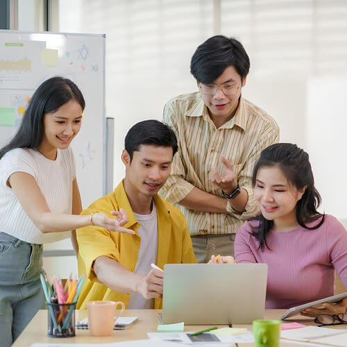 Happy Asian Web Developers Discussing Projects