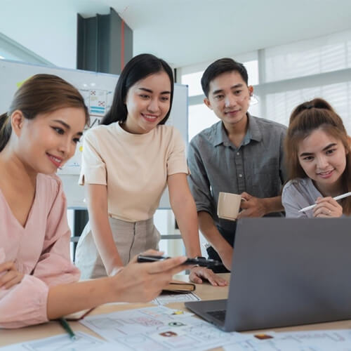 Asian Web Developers Discussing a Project