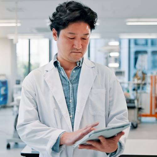 Singaporean Male Scientist Visiting Website Created By A Web Designer For Vaccine Manufacturers