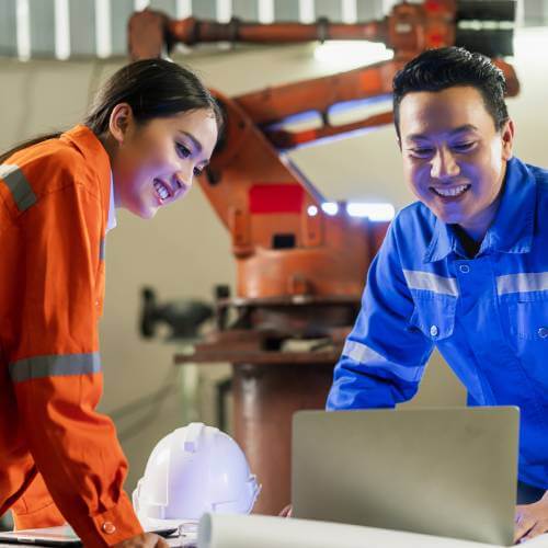 Singaporean Engineers Discussing Website Created By Website Developer For Manufacturing Sector