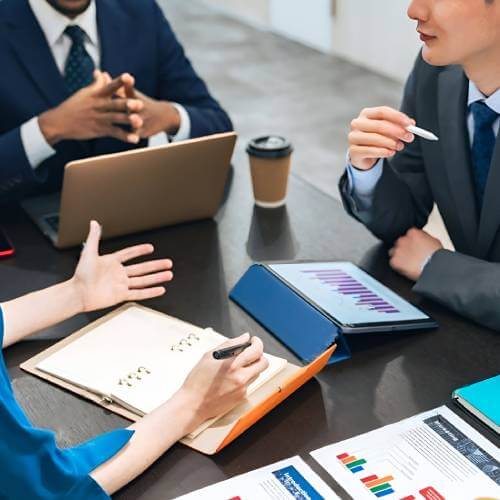 Singaporean Professionals Discussing A Platform Created By A Website Designer For Consulting Firm